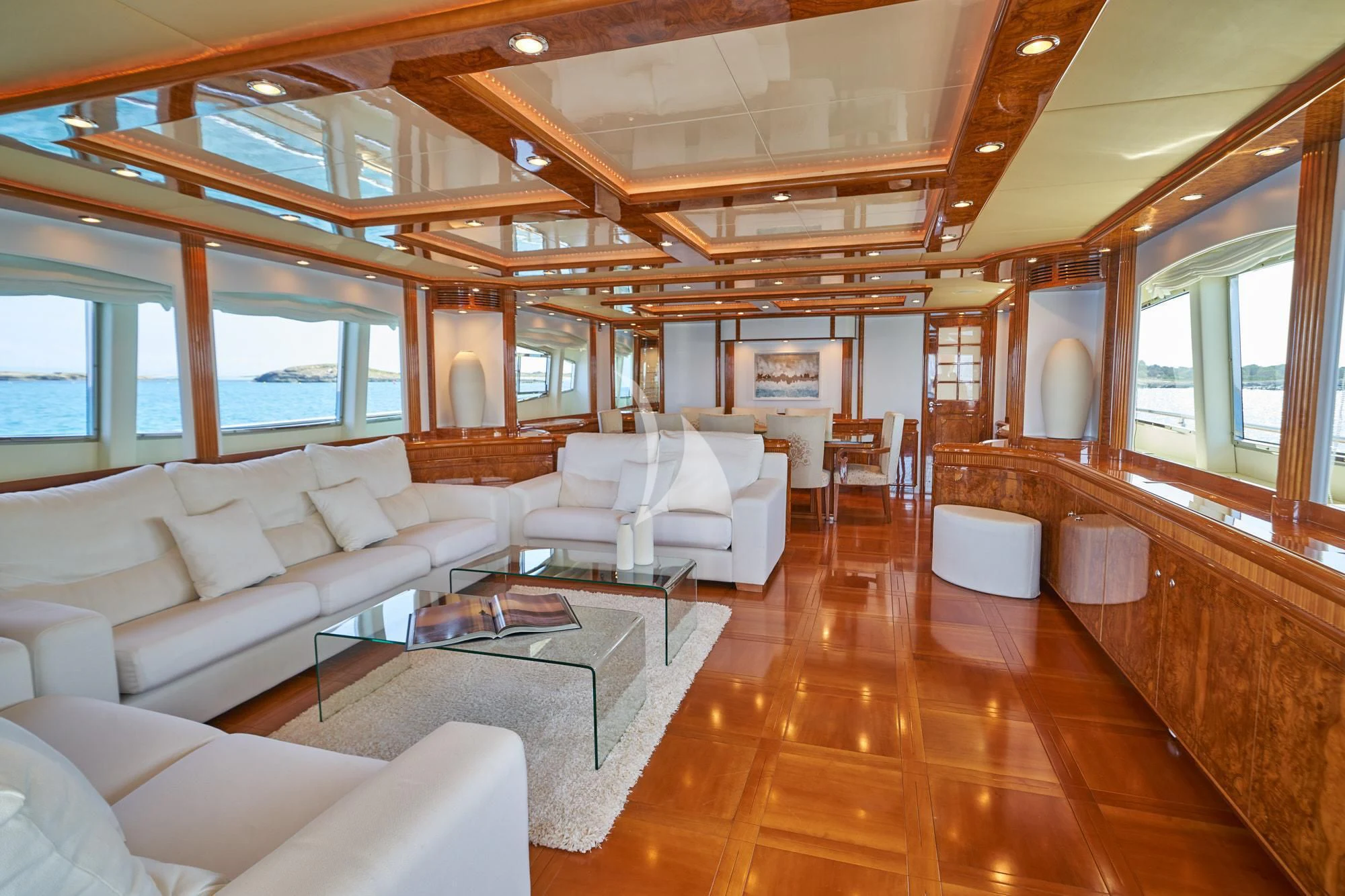 a large living room with a wood floor aboard KIRIOS Yacht for Sale