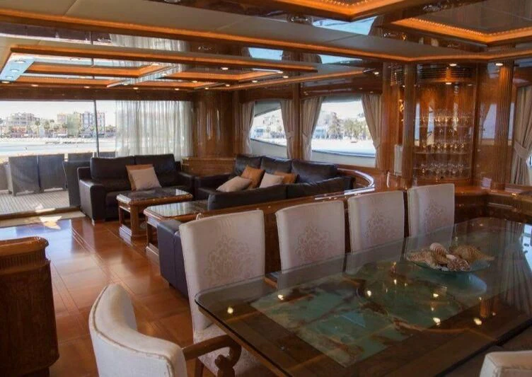 a large living room with a pool table and chairs aboard KIRIOS Yacht for Sale