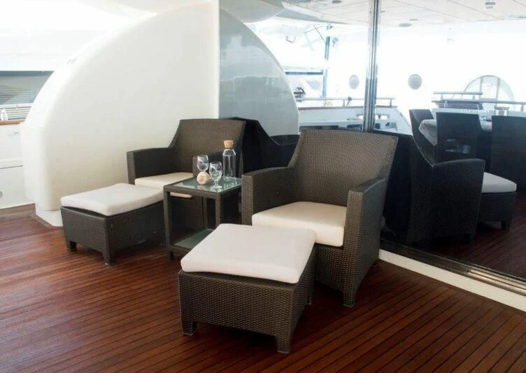 a room with a table and chairs aboard KIRIOS Yacht for Sale