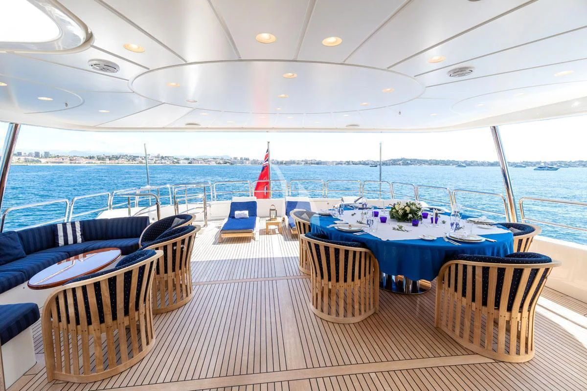 a deck with tables and chairs aboard SEA BLUEZ Yacht for Charter