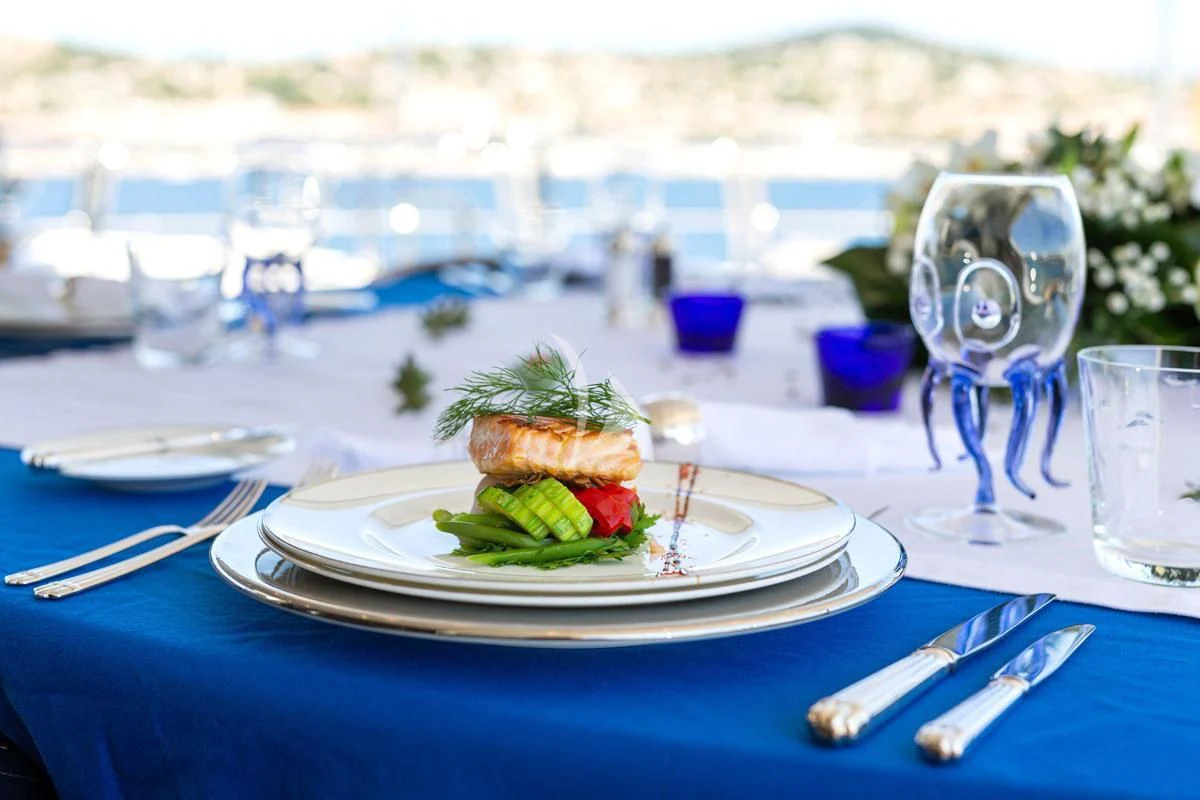 a table with plates of food and glasses on it aboard SEA BLUEZ Yacht for Charter