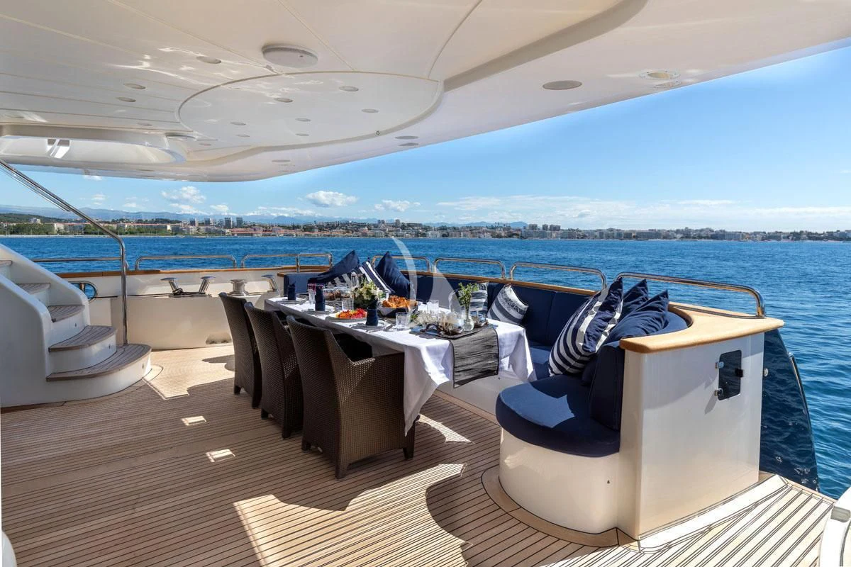 a lounge area on a deck overlooking a large body of water aboard SEA BLUEZ Yacht for Charter
