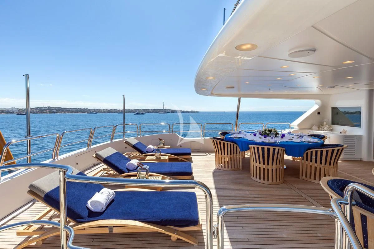 a pool with lounge chairs and umbrellas on a sunny day aboard SEA BLUEZ Yacht for Charter