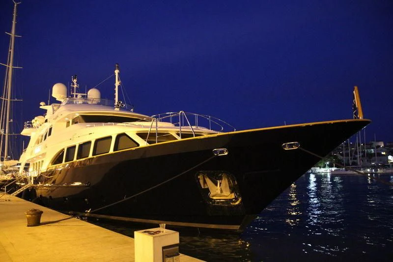 a large boat docked at a pier aboard SEA BLUEZ Yacht for Charter