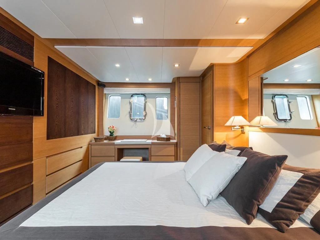 a large bedroom with a large bed aboard PASSION Yacht for Sale