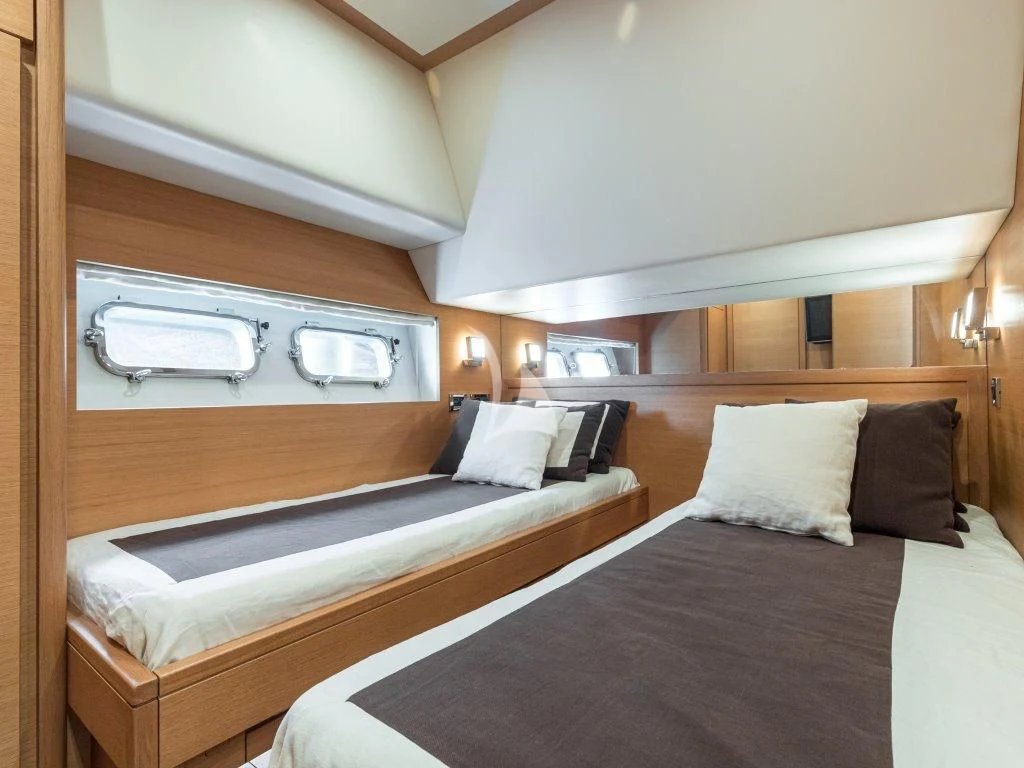 a room with a bed and a television aboard PASSION Yacht for Sale