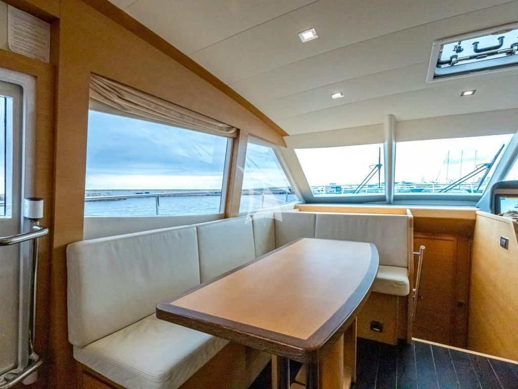 a room with a table and chairs aboard PASSION Yacht for Sale