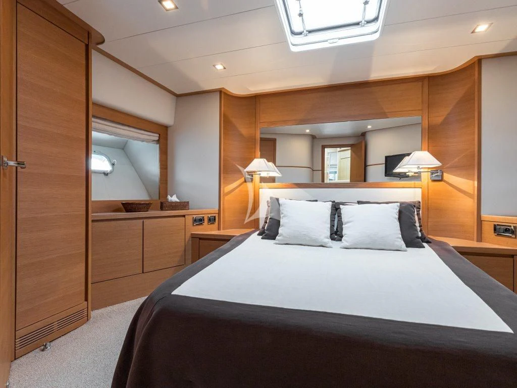 a large bedroom with a large bed aboard PASSION Yacht for Sale