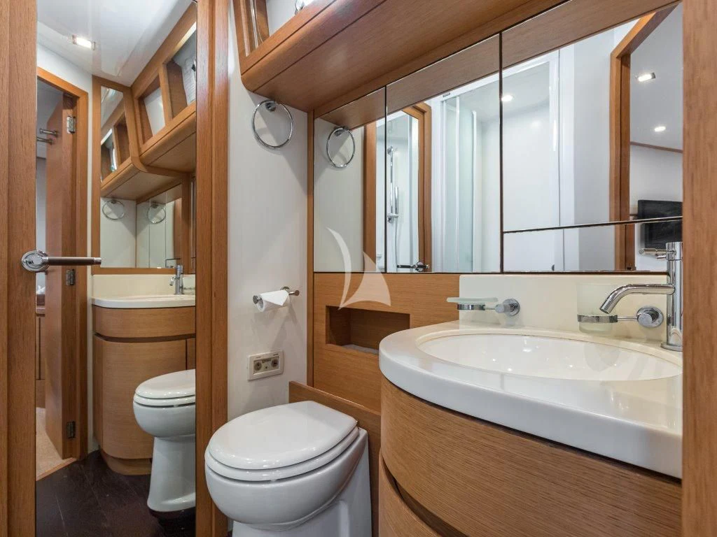 a bathroom with a toilet sink and a mirror aboard PASSION Yacht for Sale