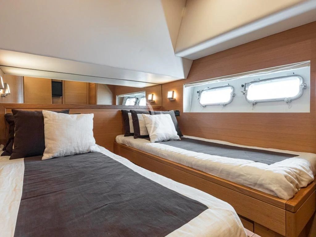 a couple of beds in a hotel room aboard PASSION Yacht for Sale