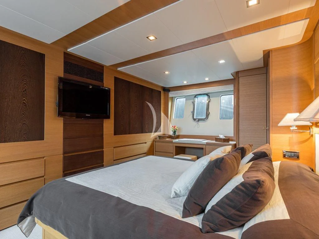 a bedroom with a bed and a television aboard PASSION Yacht for Sale