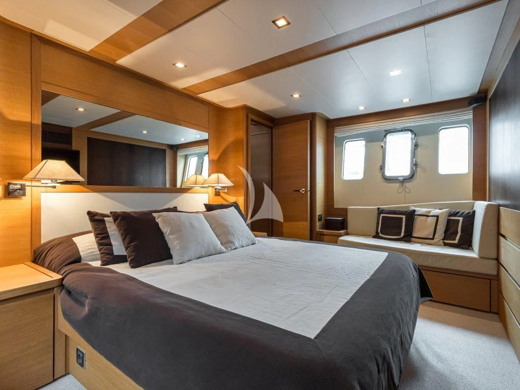 a room with a bed and a television aboard PASSION Yacht for Sale