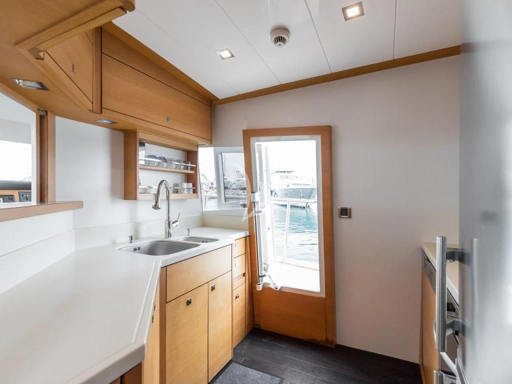 a kitchen with a sink and a window aboard PASSION Yacht for Sale