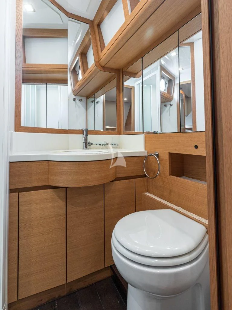 a bathroom with a toilet and a sink aboard PASSION Yacht for Sale