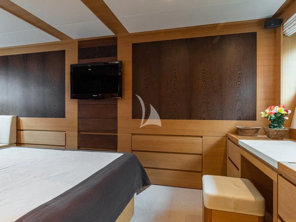 a room with a bed and a tv aboard PASSION Yacht for Sale