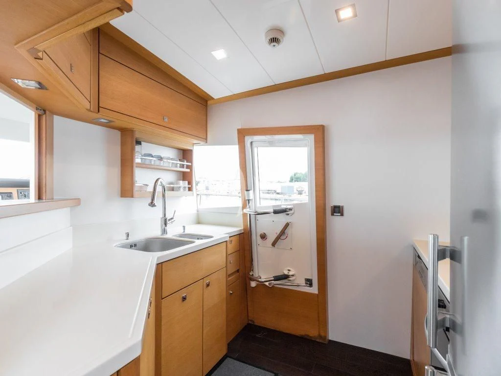 a kitchen with a sink and a mirror aboard PASSION Yacht for Sale