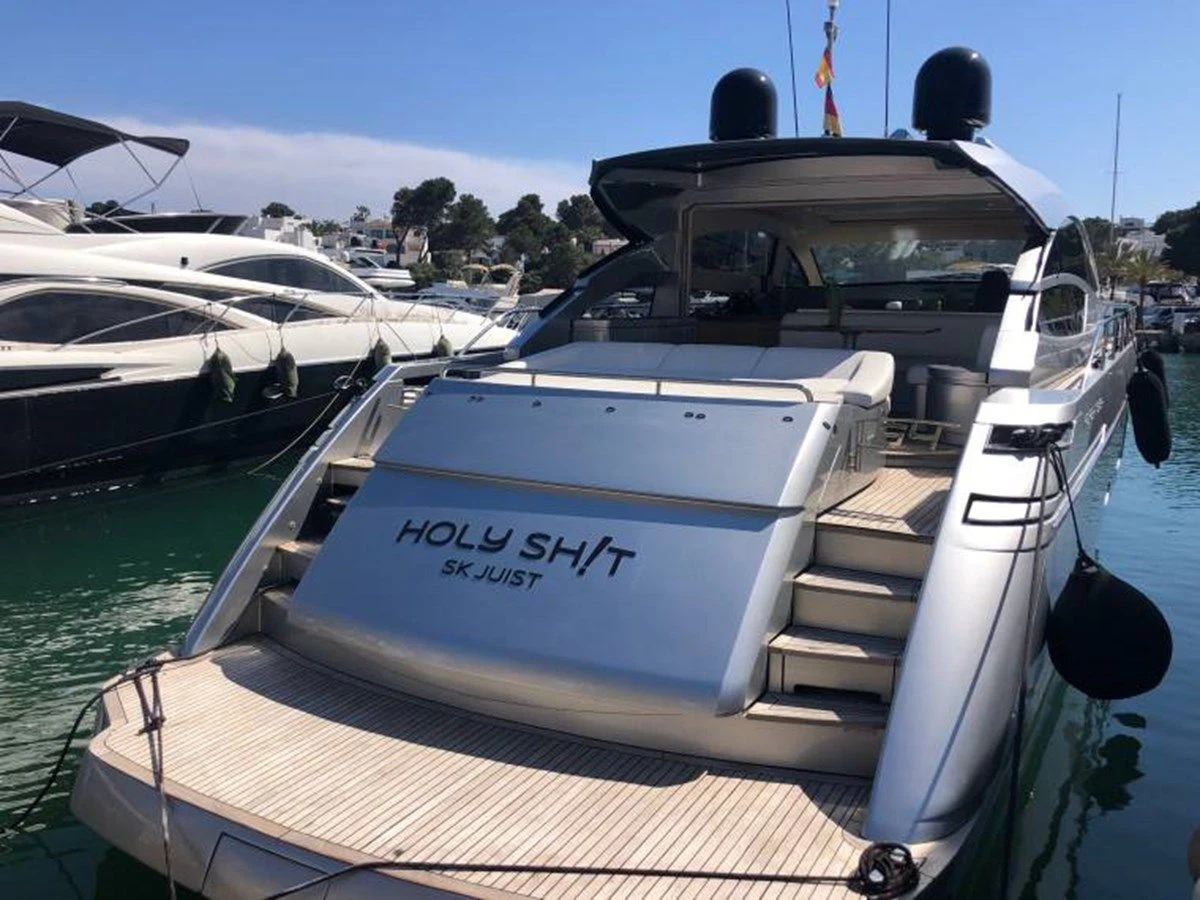 a boat is parked in the water aboard HOLY SHIT Yacht for Sale