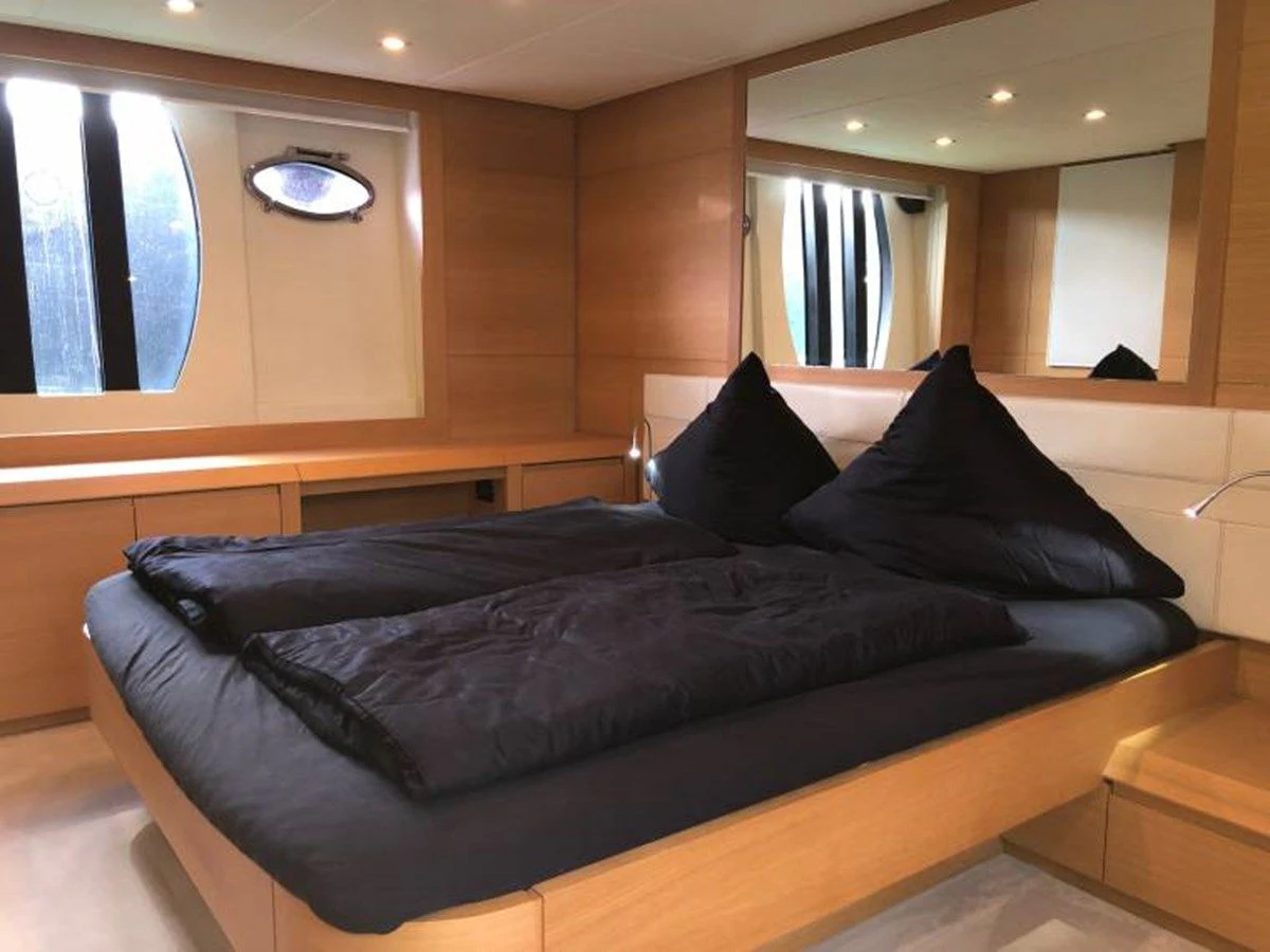a black couch in a room aboard HOLY SHIT Yacht for Sale