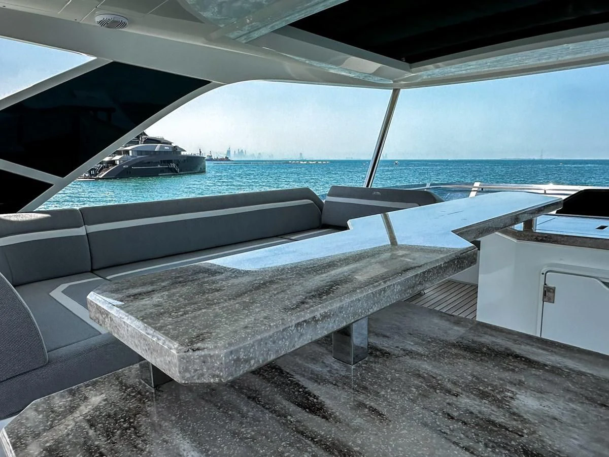 a pool with a deck and a boat in the background aboard JANICE Yacht for Sale