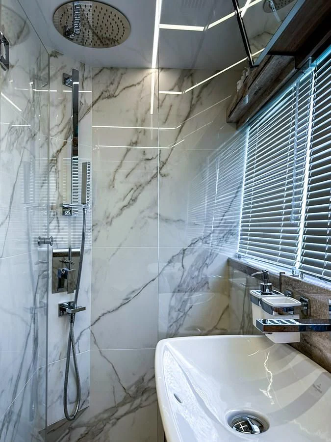 a bathroom with a shower and sink aboard JANICE Yacht for Sale