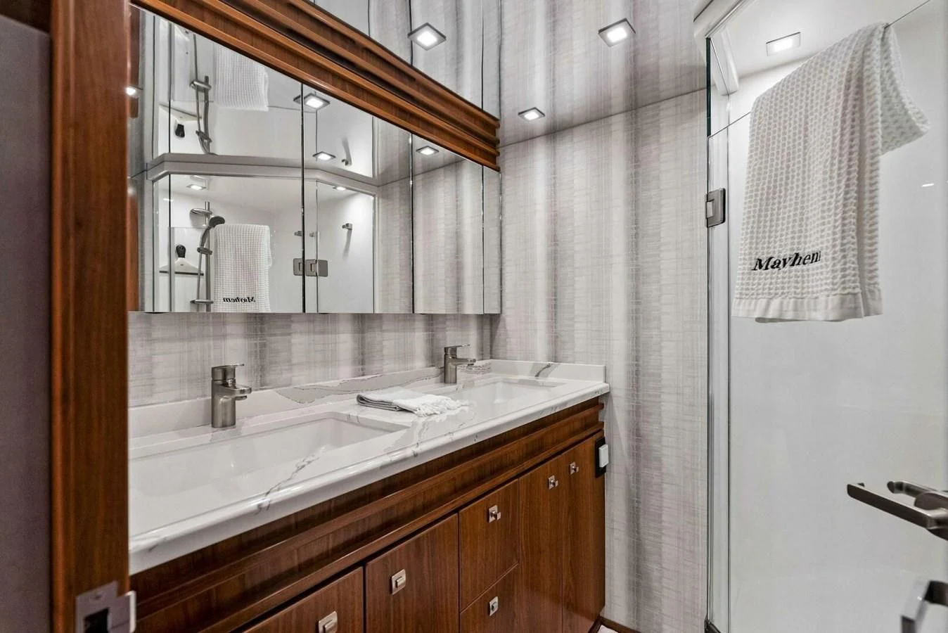 a bathroom with a sink and mirror aboard TEAM MAYHEM Yacht for Sale