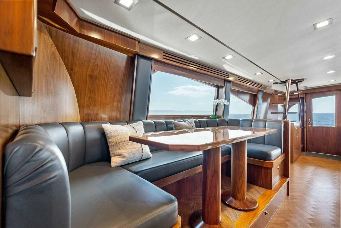 a living room with a couch and a table aboard TEAM MAYHEM Yacht for Sale