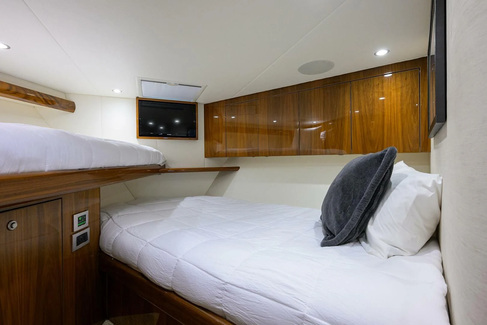 a bed with white sheets aboard TEAM MAYHEM Yacht for Sale