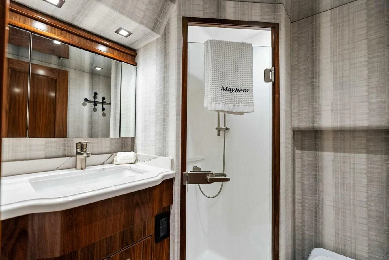 a bathroom with a mirror and sink aboard TEAM MAYHEM Yacht for Sale