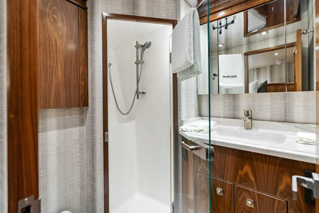 a bathroom with a mirror and a sink aboard TEAM MAYHEM Yacht for Sale