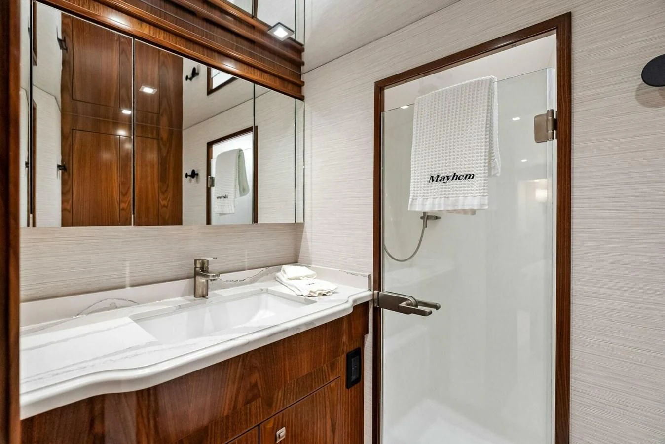 a bathroom with a mirror and a sink aboard TEAM MAYHEM Yacht for Sale