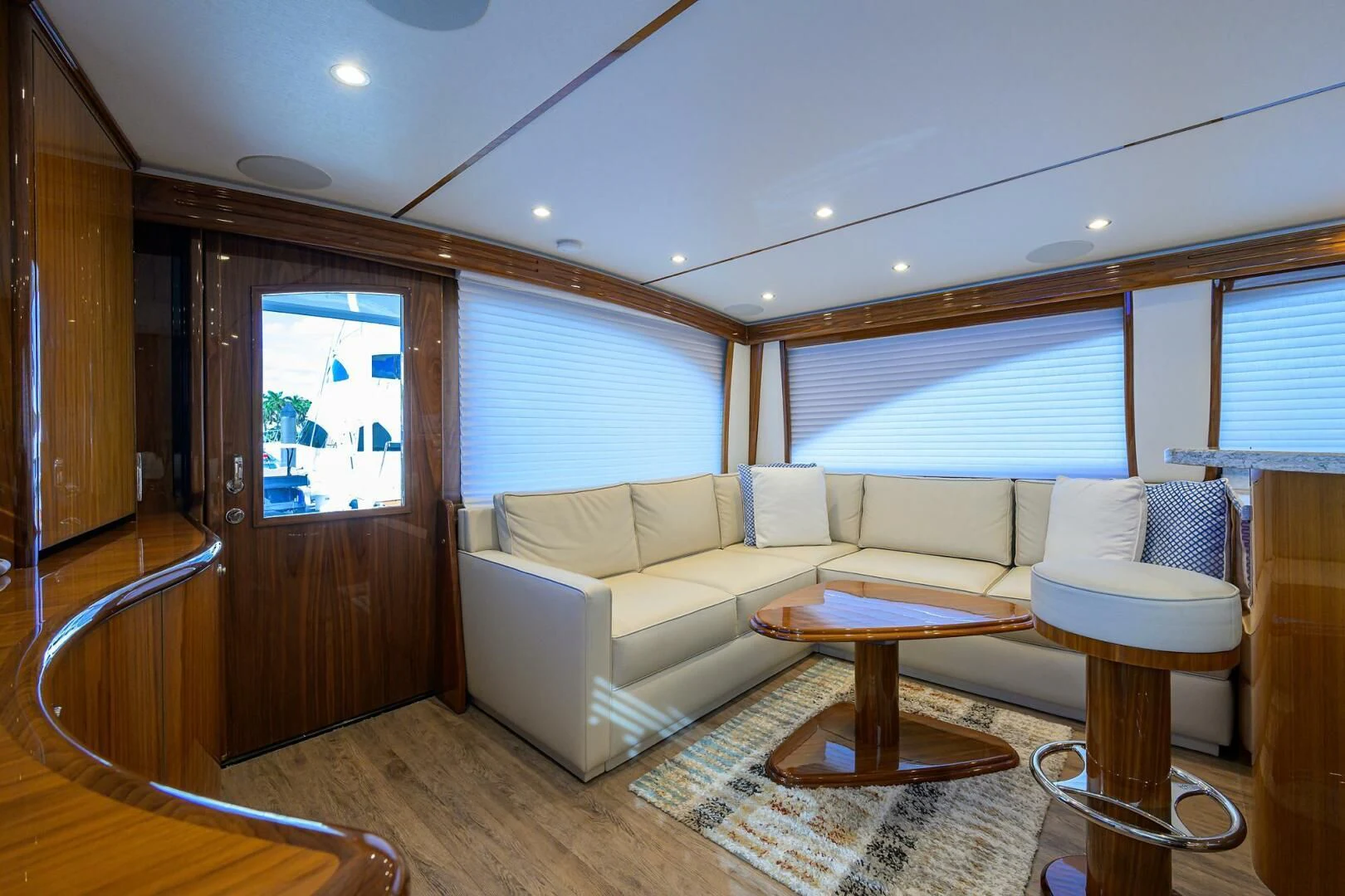 a living room with a couch and a table aboard TEAM MAYHEM Yacht for Sale