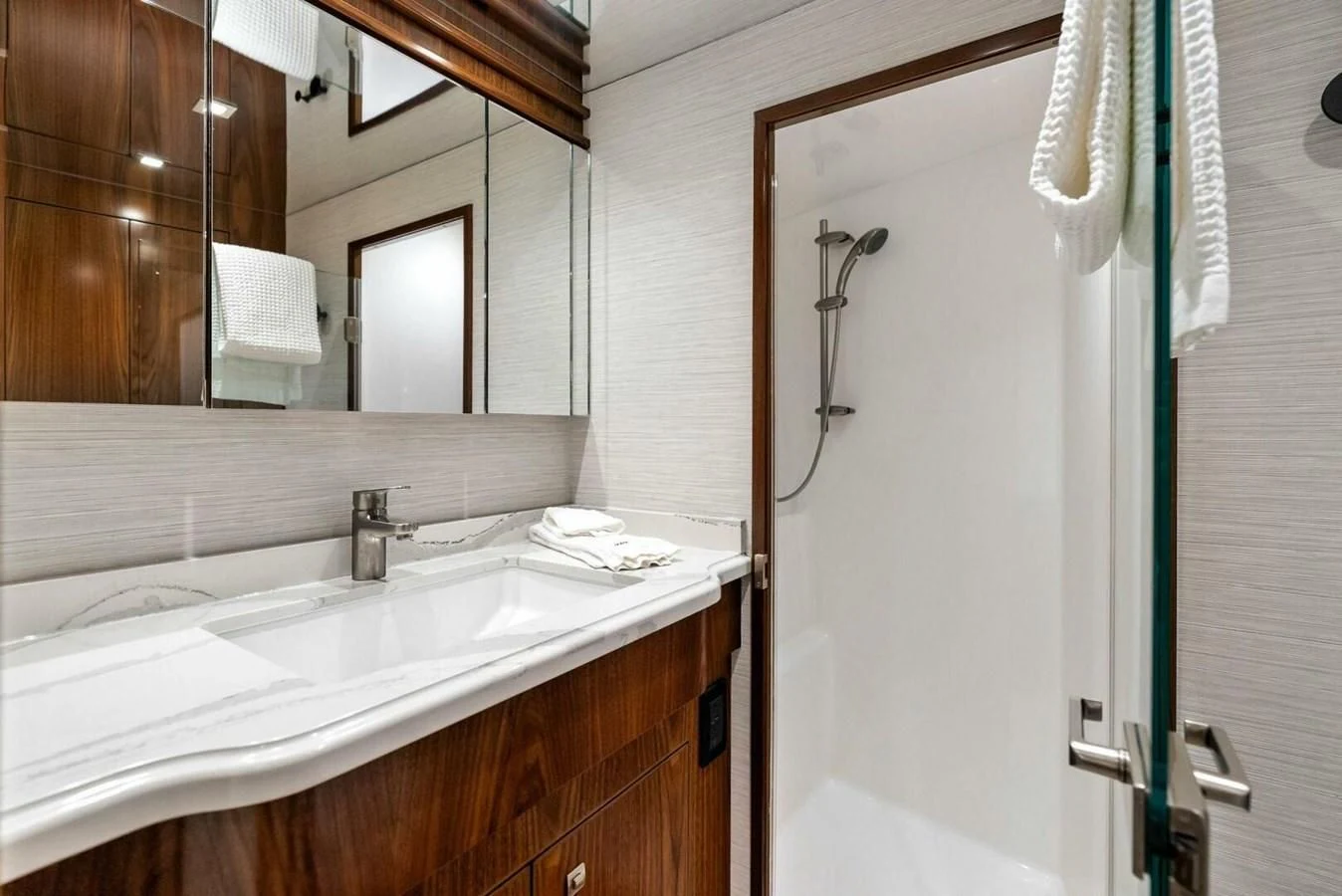 a bathroom with a sink and a mirror aboard TEAM MAYHEM Yacht for Sale