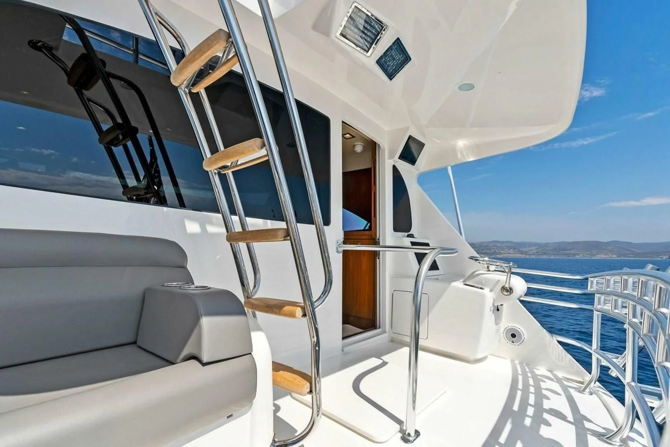 a boat with a deck and chairs aboard TEAM MAYHEM Yacht for Sale