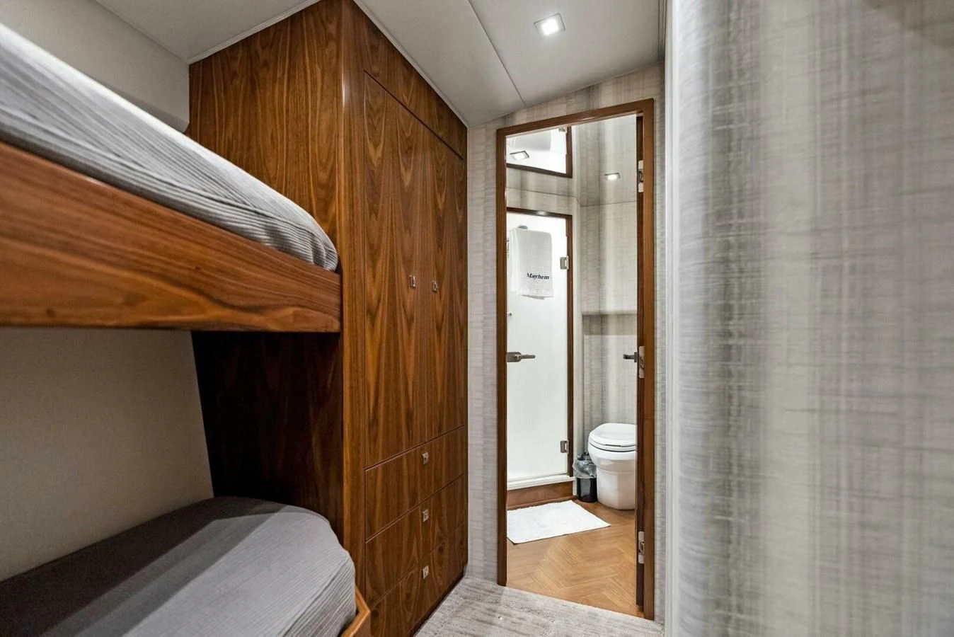 a room with a bed and a closet aboard TEAM MAYHEM Yacht for Sale