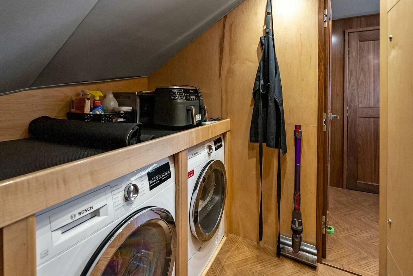 a kitchen with a washing machine and a dryer aboard TEAM MAYHEM Yacht for Sale
