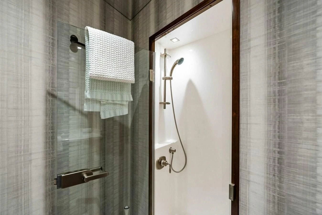a bathroom with a shower and a towel on the wall aboard TEAM MAYHEM Yacht for Sale