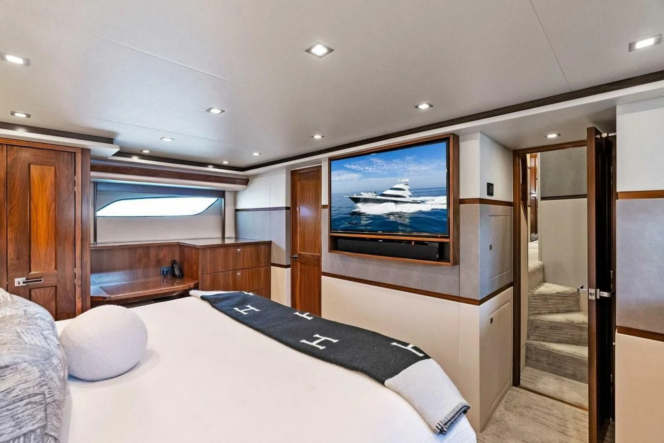 a bedroom with a large tv aboard TEAM MAYHEM Yacht for Sale