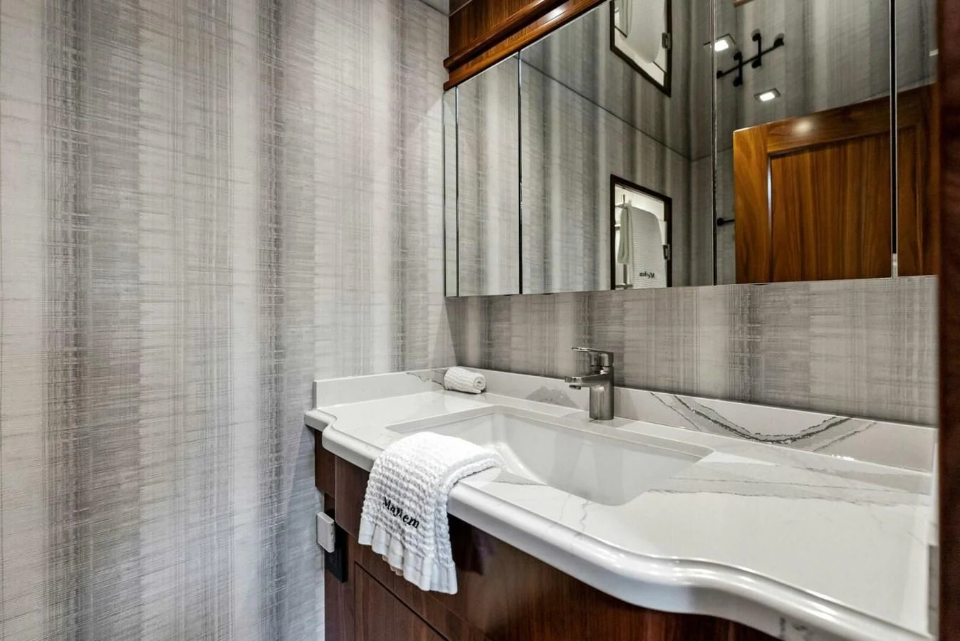 a bathroom with a sink and a mirror aboard TEAM MAYHEM Yacht for Sale