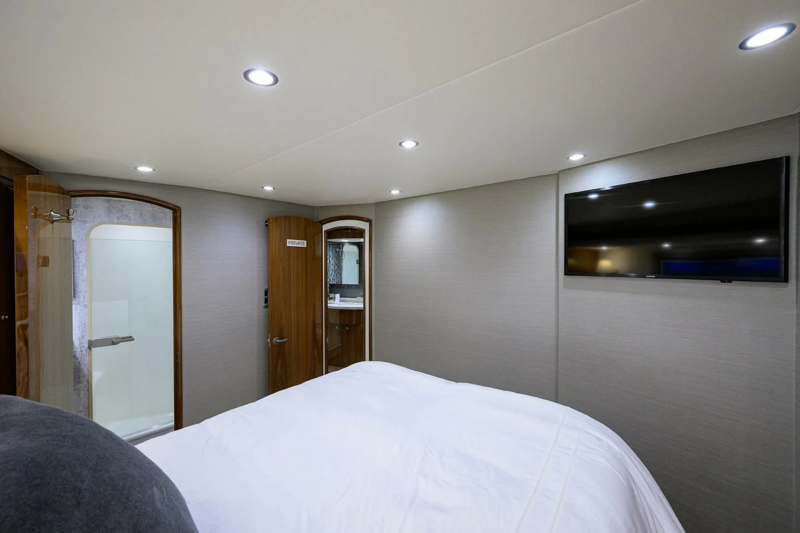 a bedroom with a bed and a closet aboard TEAM MAYHEM Yacht for Sale