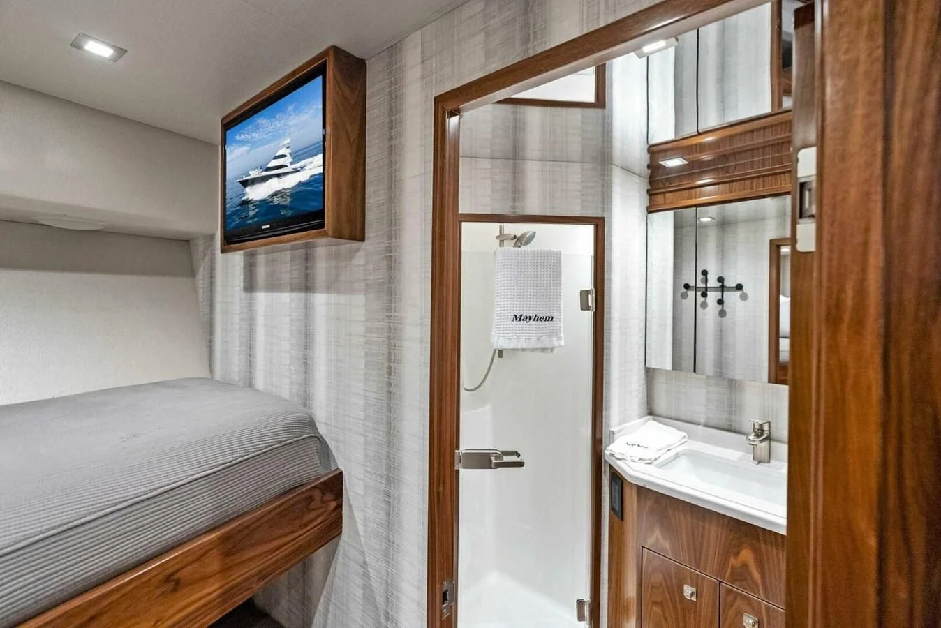 a bathroom with a bed and a television aboard TEAM MAYHEM Yacht for Sale