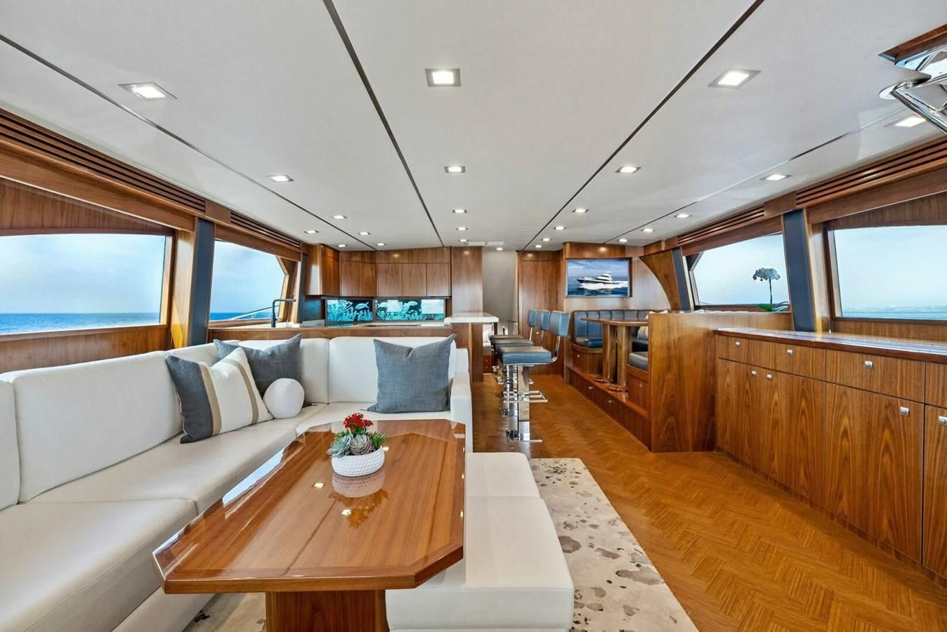 a large room with a couch and a table aboard TEAM MAYHEM Yacht for Sale