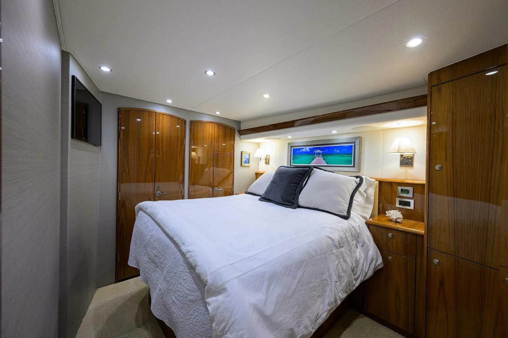 a bedroom with a bed and a television aboard TEAM MAYHEM Yacht for Sale