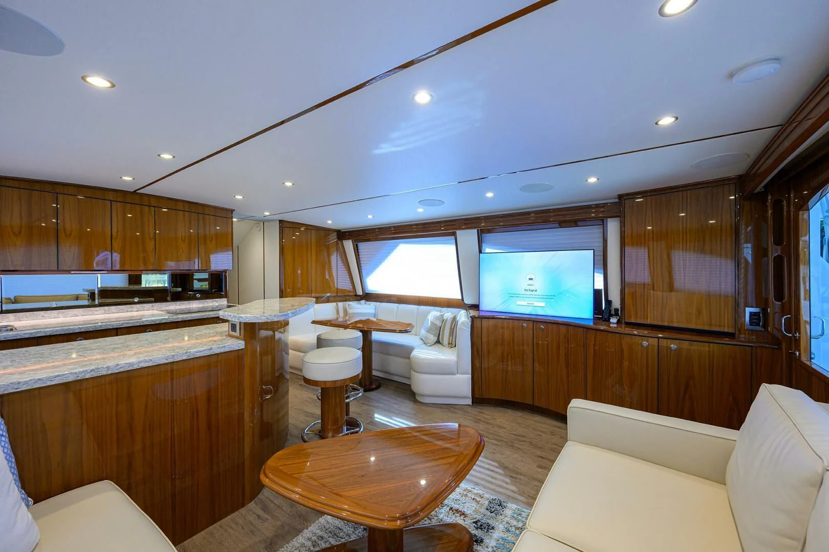 a large kitchen with wooden cabinets aboard TEAM MAYHEM Yacht for Sale