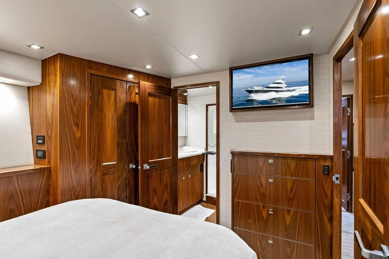 a bedroom with a bed and a television on the wall aboard TEAM MAYHEM Yacht for Sale