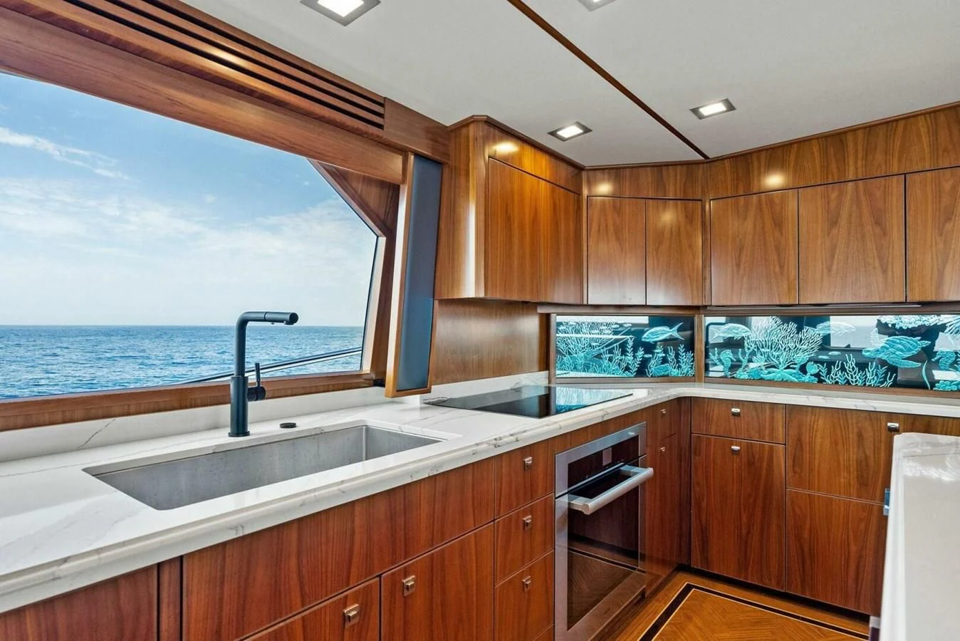 a kitchen with wooden cabinets aboard TEAM MAYHEM Yacht for Sale