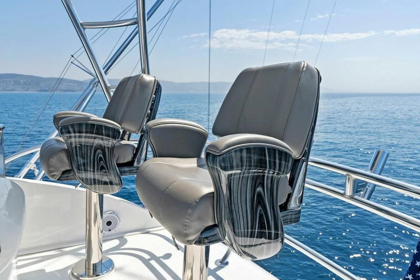 a boat with a couple chairs on it aboard TEAM MAYHEM Yacht for Sale