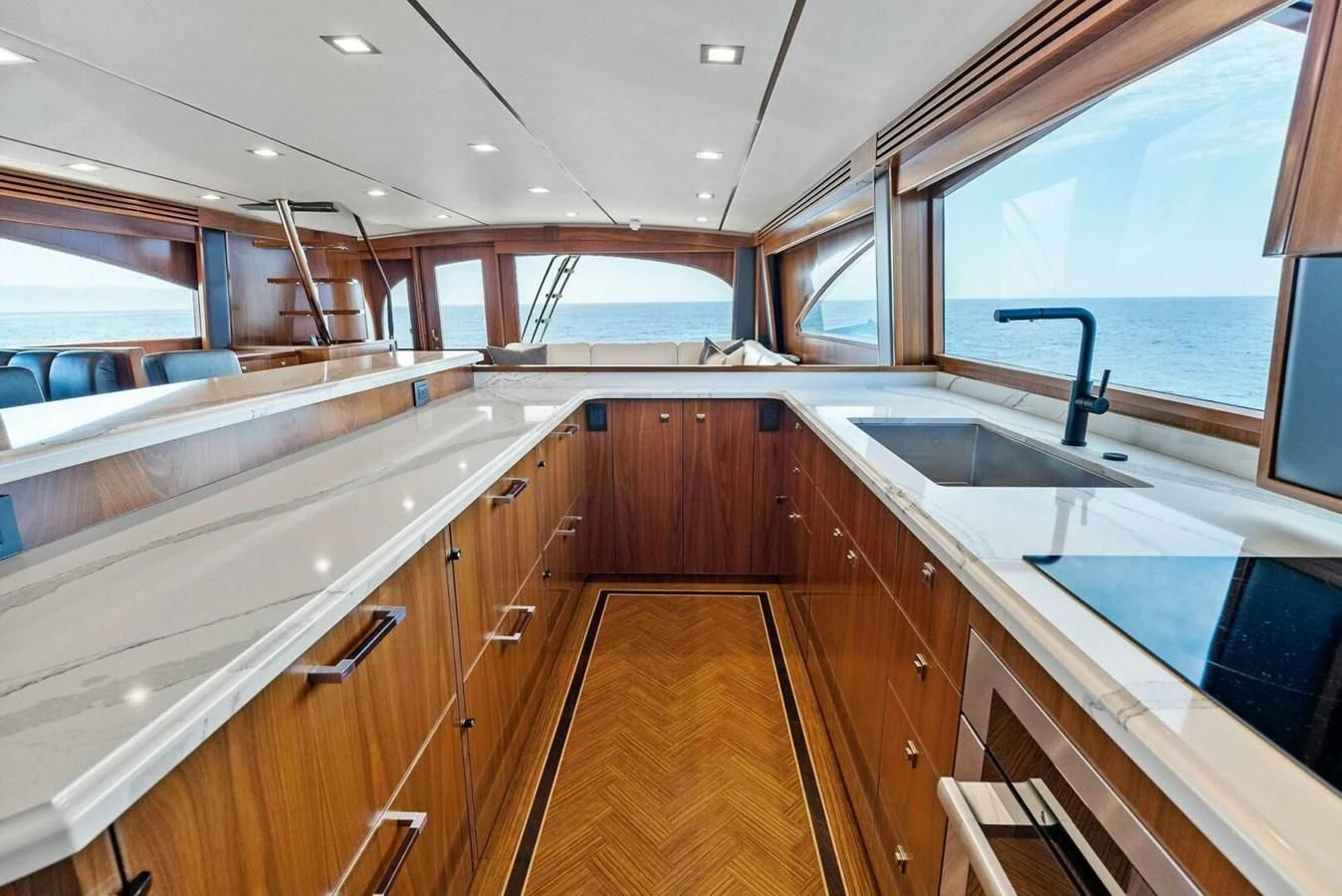 a kitchen with wooden cabinets aboard TEAM MAYHEM Yacht for Sale
