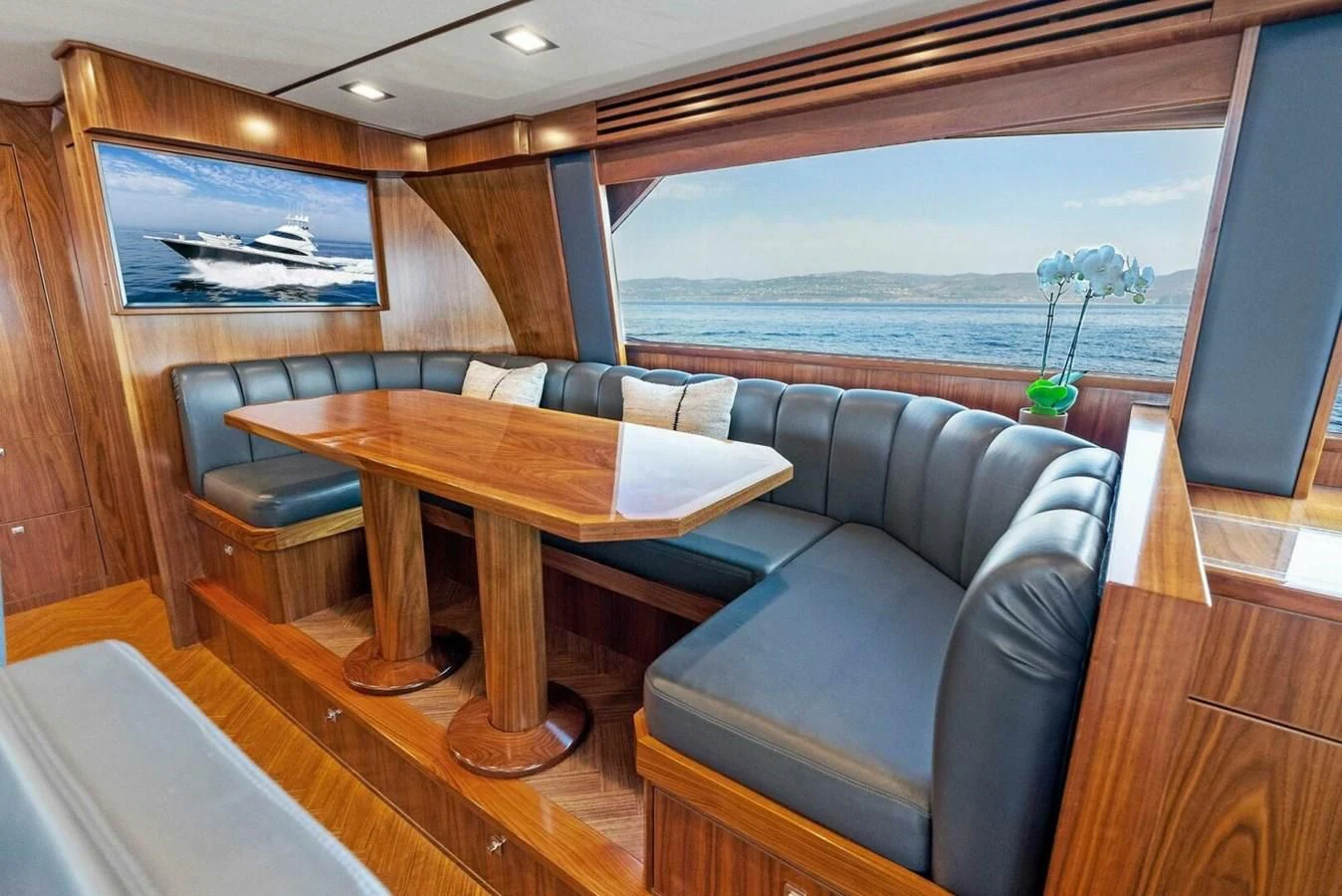 a living room with a couch and a table aboard TEAM MAYHEM Yacht for Sale