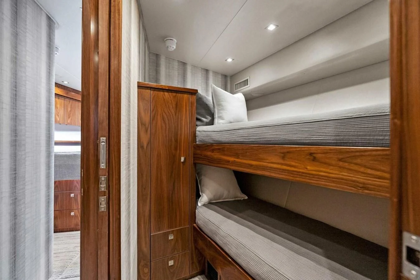 a room with a bed and a door aboard TEAM MAYHEM Yacht for Sale
