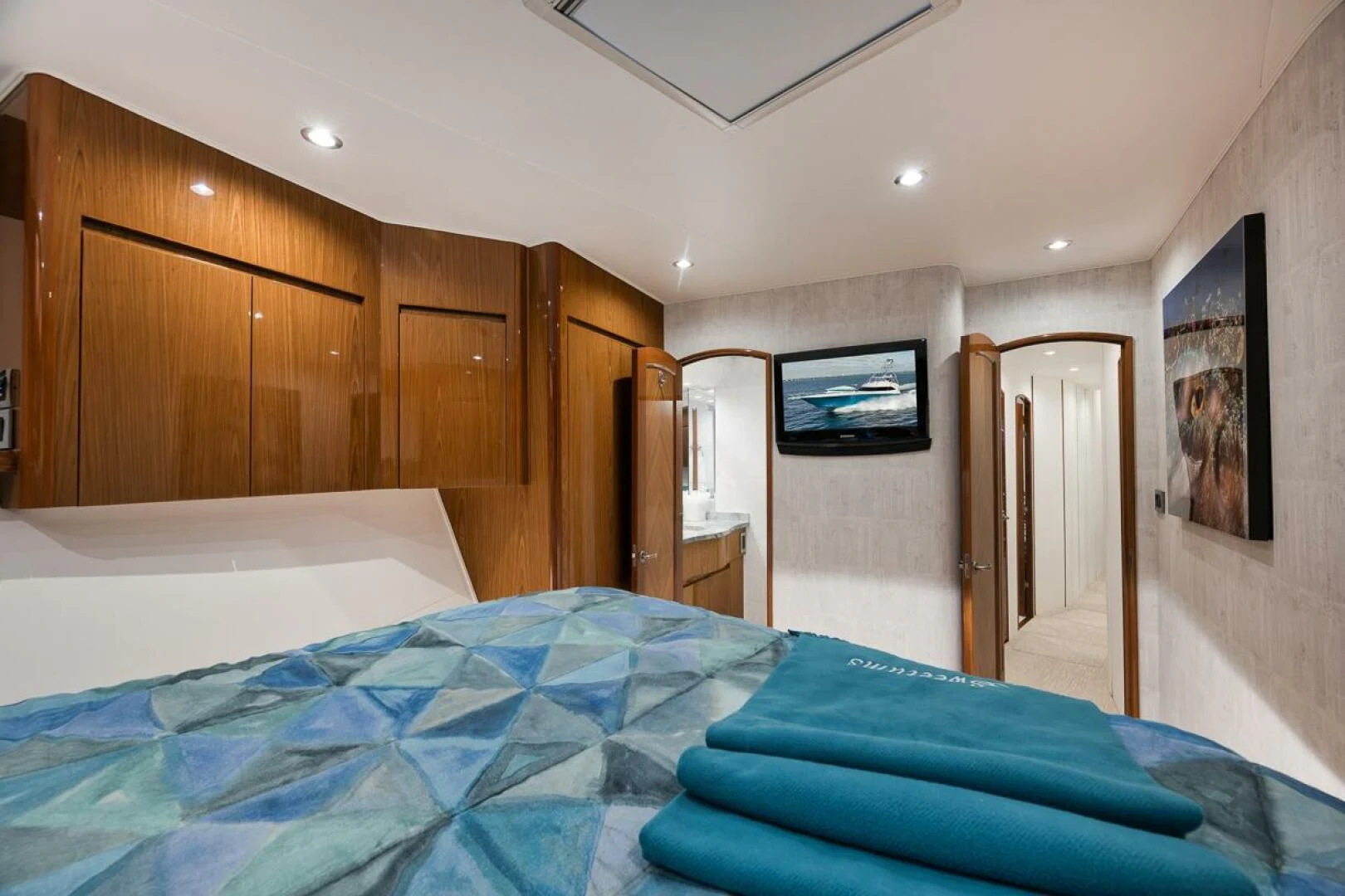 a bedroom with a bed and a television aboard DOC Z Yacht for Sale